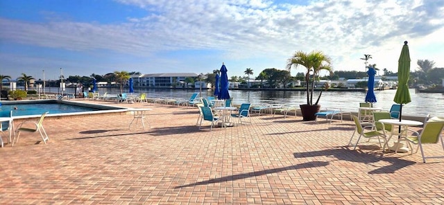 2006 S Federal Hwy S Unit 102, Boynton Beach, FL 33435 - exterior space featuring a water view, a swimming pool, and a patio area