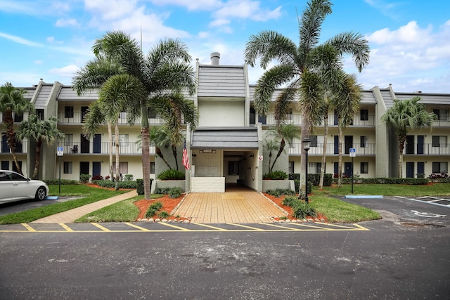 view of property featuring uncovered parking