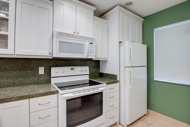 living area with recessed lighting, baseboards, and light tile patterned flooring