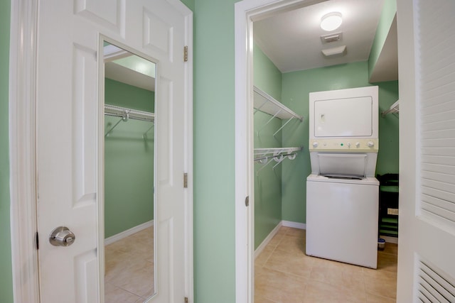 4801 Esedra Ct Unit 104, Lake Worth, FL 33467 - clothes washing area featuring laundry area, stacked washing maching and dryer, baseboards, light tile patterned floors, and visible vents