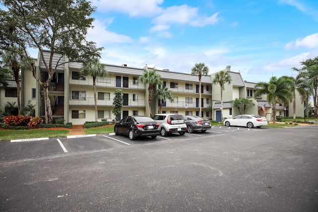 view of building exterior featuring uncovered parking