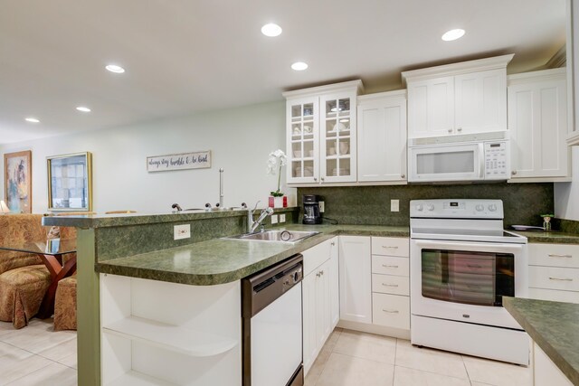 kitchen with backsplash, dark countertops, light tile patterned floors, and built in study area