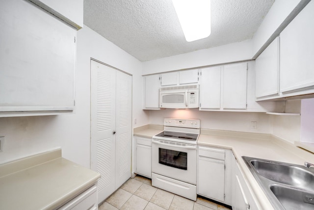 kitchen featuring a textured ceiling, white cabinets, a sink, light countertops, and white appliances