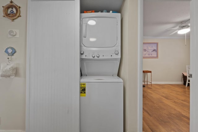 4201 S Ocean Blvd Unit I1, Palm Beach, FL 33480 - washroom with laundry area, wood finished floors, baseboards, stacked washing maching and dryer, and ceiling fan