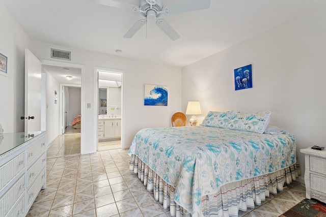 bedroom featuring visible vents, ensuite bathroom, light tile patterned floors, and ceiling fan