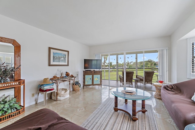 living room with baseboards and light tile patterned floors