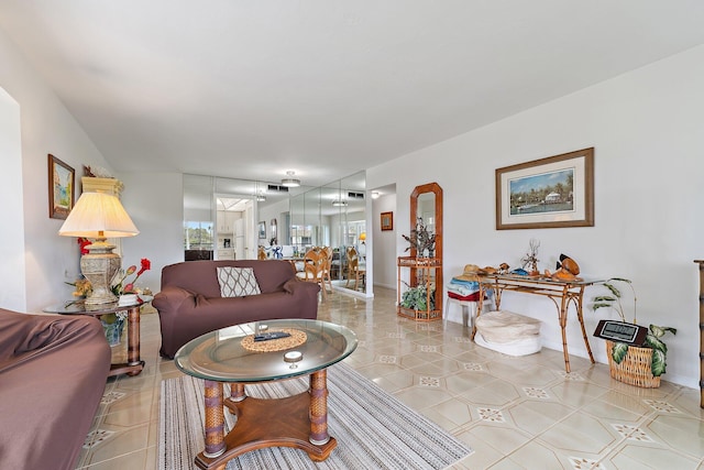 living room with baseboards and light tile patterned floors