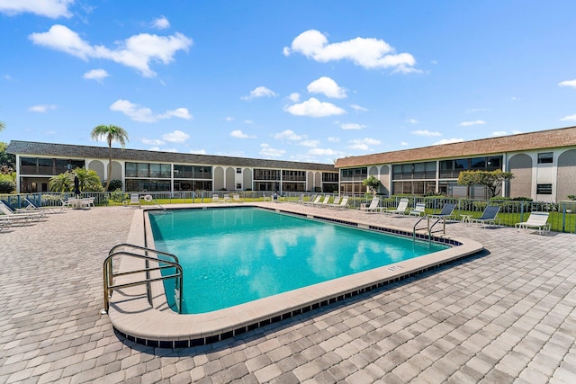 pool with fence and a patio area