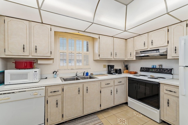 kitchen featuring a sink, light countertops, under cabinet range hood, white appliances, and light tile patterned flooring