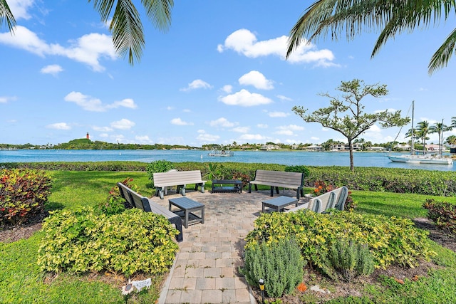 view of property's community with a patio and a water view