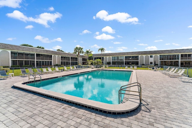 community pool featuring a patio and fence
