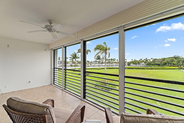 sunroom / solarium with a water view