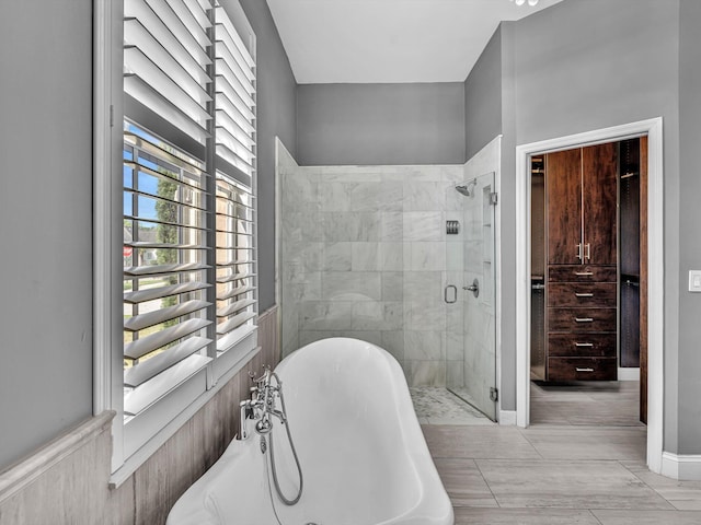 full bathroom with radiator heating unit, a freestanding tub, and a stall shower
