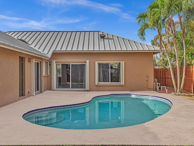 view of swimming pool with fence, a fenced in pool, and a patio area
