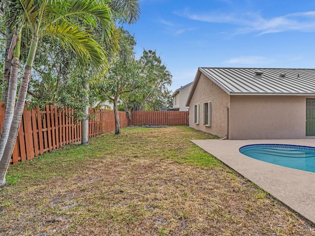 view of yard with a fenced backyard, a fenced in pool, and a patio area