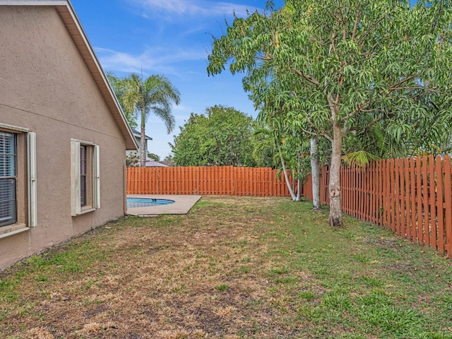 view of yard with a fenced backyard and a fenced in pool