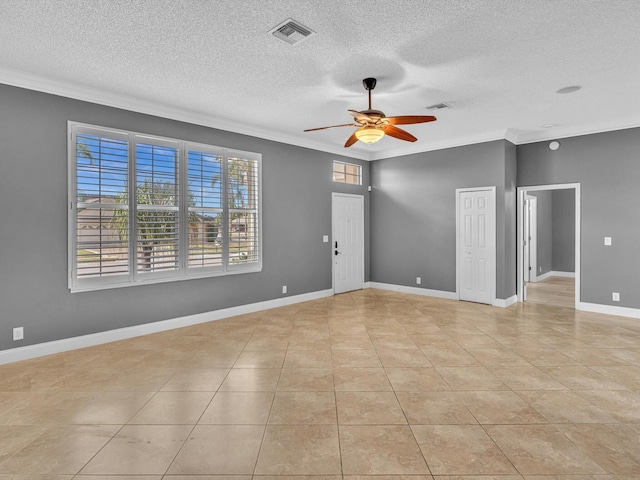 unfurnished room featuring a textured ceiling, ornamental molding, ceiling fan, and visible vents
