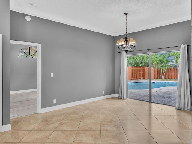 unfurnished dining area with a textured ceiling, light tile patterned floors, baseboards, an inviting chandelier, and ornamental molding
