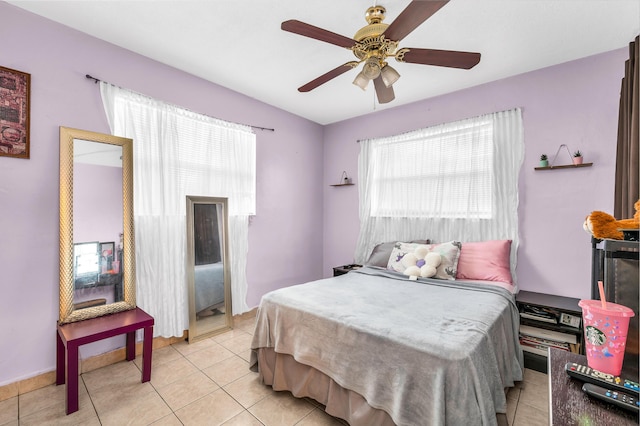 bedroom featuring light tile patterned floors and ceiling fan