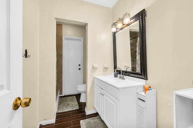 full bath featuring wood finished floors, toilet, and vanity
