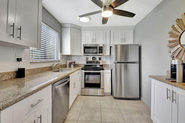 15108 Ashland Dr Unit 185, Delray Beach, FL 33484 - kitchen featuring light stone counters, white cabinets, a sink, stainless steel appliances, and a ceiling fan