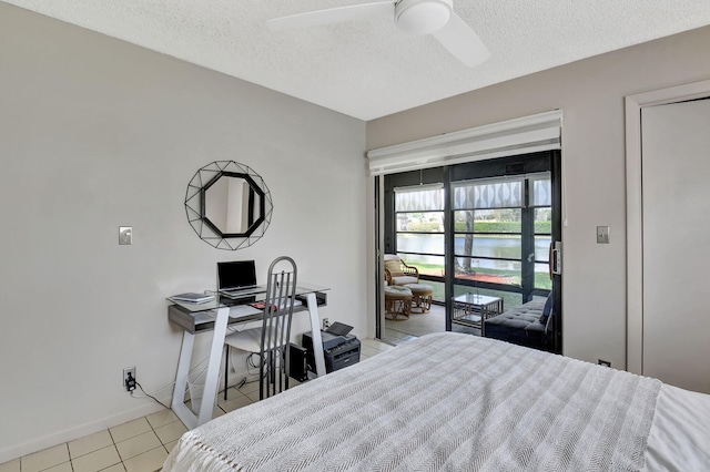 15108 Ashland Dr Unit 185, Delray Beach, FL 33484 - bedroom with a textured ceiling, ceiling fan, baseboards, and light tile patterned flooring