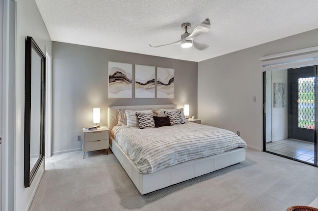15108 Ashland Dr Unit 185, Delray Beach, FL 33484 - bedroom with a textured ceiling, light colored carpet, ceiling fan, baseboards, and access to outside