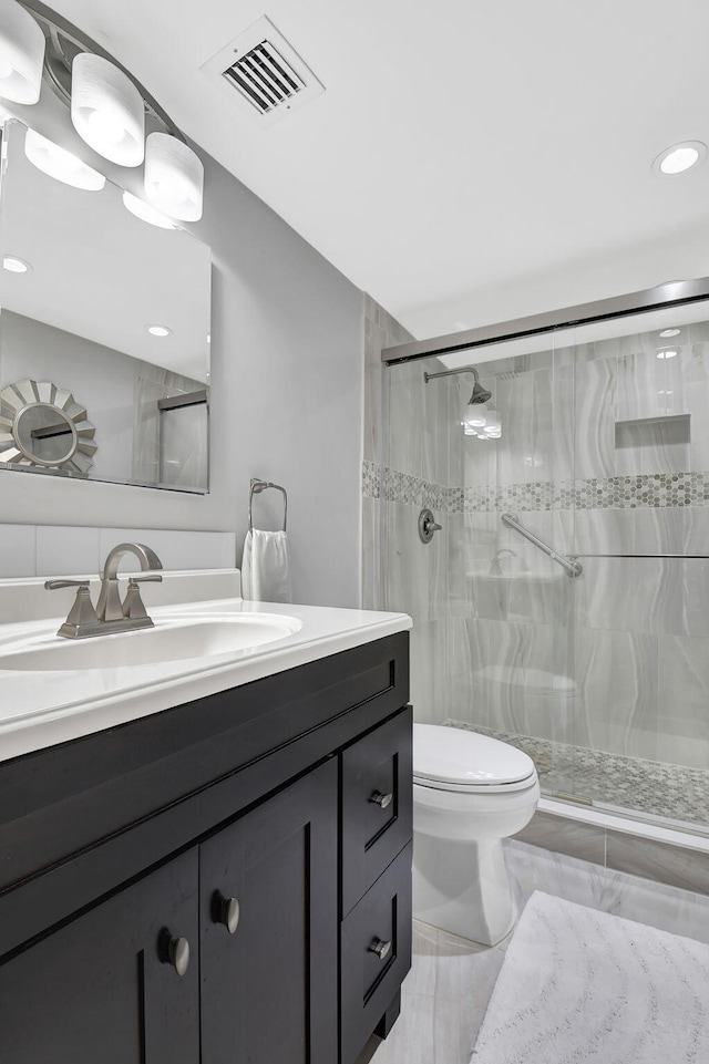 15108 Ashland Dr Unit 185, Delray Beach, FL 33484 - bathroom featuring toilet, visible vents, vanity, and a shower stall