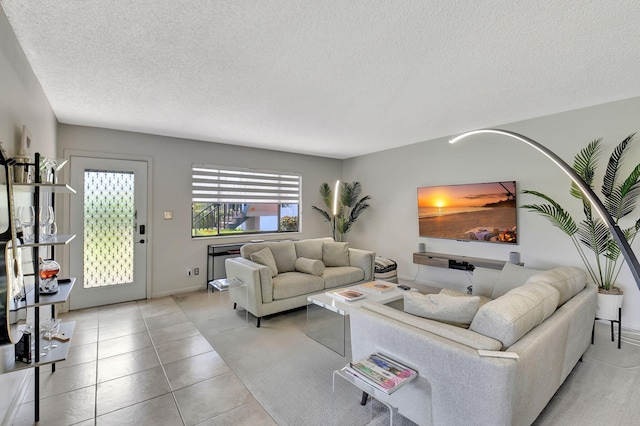 15108 Ashland Dr Unit 185, Delray Beach, FL 33484 - living room with light tile patterned floors, a textured ceiling, and baseboards