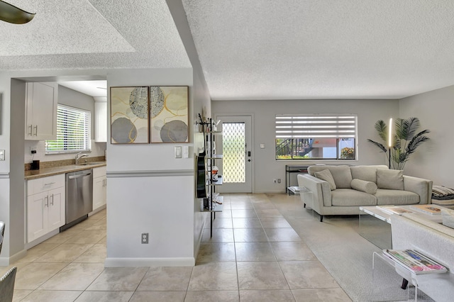 15108 Ashland Dr Unit 185, Delray Beach, FL 33484 - living area with light tile patterned floors, a textured ceiling, and baseboards