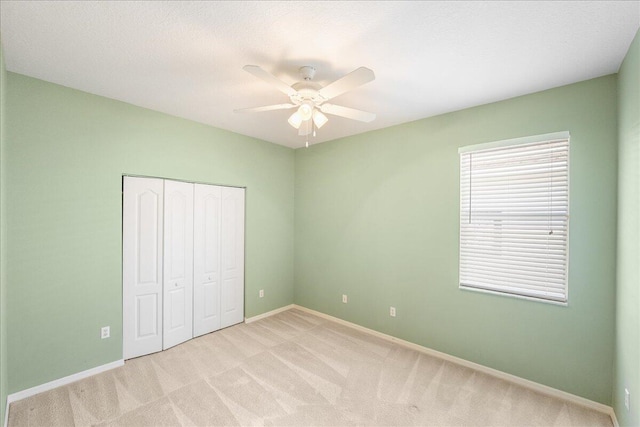 9925 SW Stonegate Dr, Port Saint Lucie, FL 34987 - unfurnished bedroom featuring a closet, light colored carpet, baseboards, and a ceiling fan