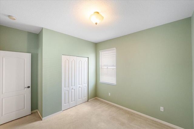 9925 SW Stonegate Dr, Port Saint Lucie, FL 34987 - unfurnished bedroom featuring carpet floors, a closet, and baseboards