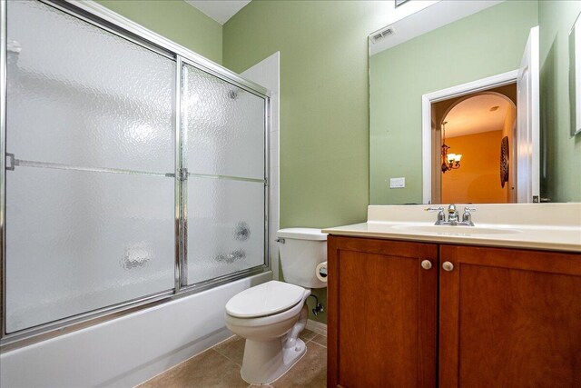 9925 SW Stonegate Dr, Port Saint Lucie, FL 34987 - full bath with toilet, vanity, combined bath / shower with glass door, and tile patterned flooring