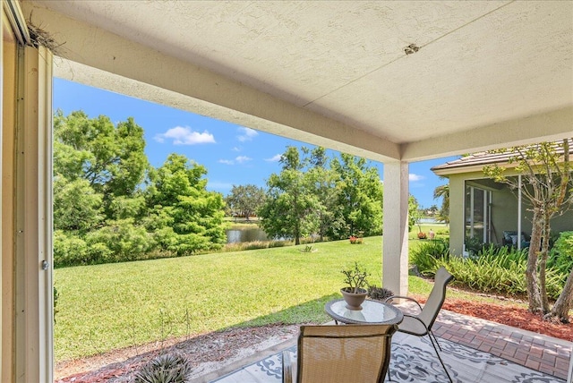 9925 SW Stonegate Dr, Port Saint Lucie, FL 34987 - view of patio featuring a water view and view of scattered trees