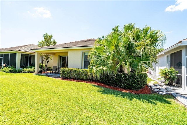 9925 SW Stonegate Dr, Port Saint Lucie, FL 34987 - rear view of house with a yard and stucco siding