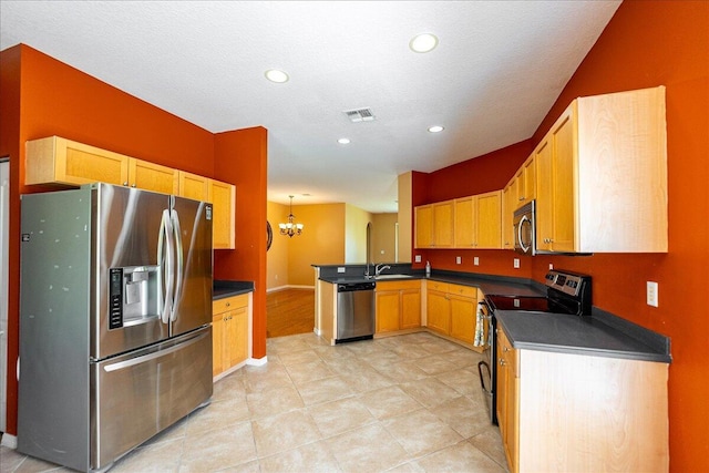 9925 SW Stonegate Dr, Port Saint Lucie, FL 34987 - kitchen featuring stainless steel appliances, dark countertops, a sink, a chandelier, and a peninsula