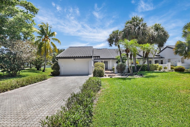 14 Windsor Ln, Boynton Beach, FL 33436 - view of front facade featuring decorative driveway, a garage, stucco siding, and a front yard