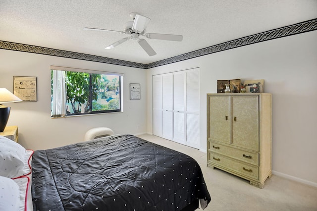 14 Windsor Ln, Boynton Beach, FL 33436 - bedroom with light colored carpet, a closet, ceiling fan, and a textured ceiling
