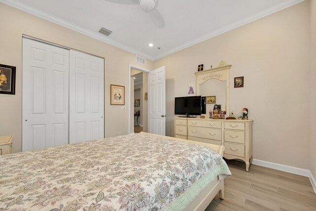 1055 Ember Ridge Run, Loxahatchee, FL 33470 - bedroom featuring a closet, crown molding, light wood-style flooring, baseboards, and a ceiling fan