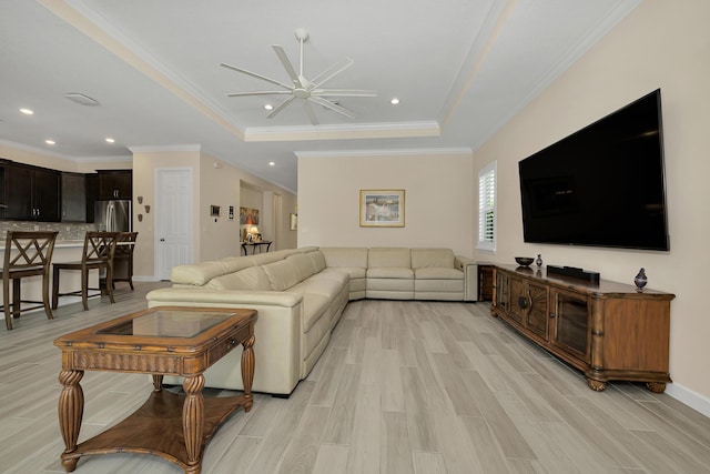 1055 Ember Ridge Run, Loxahatchee, FL 33470 - living room with ceiling fan, a tray ceiling, light wood-style flooring, crown molding, and recessed lighting
