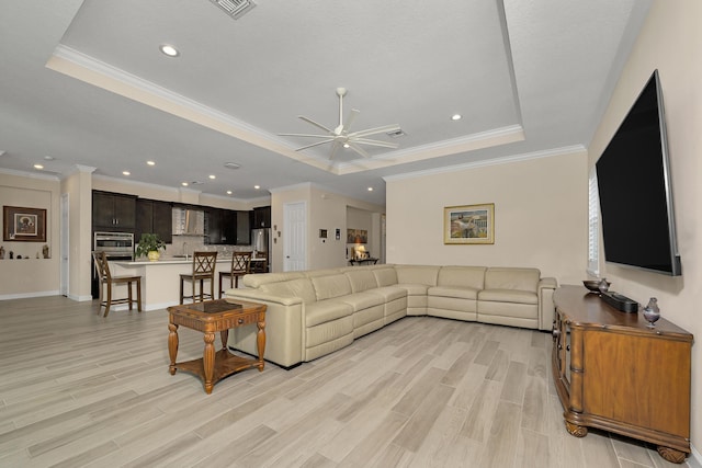 1055 Ember Ridge Run, Loxahatchee, FL 33470 - living room with a tray ceiling, ceiling fan, light wood-type flooring, recessed lighting, and baseboards