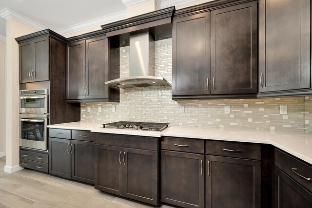1055 Ember Ridge Run, Loxahatchee, FL 33470 - kitchen with appliances with stainless steel finishes, ornamental molding, wall chimney exhaust hood, decorative backsplash, and light countertops