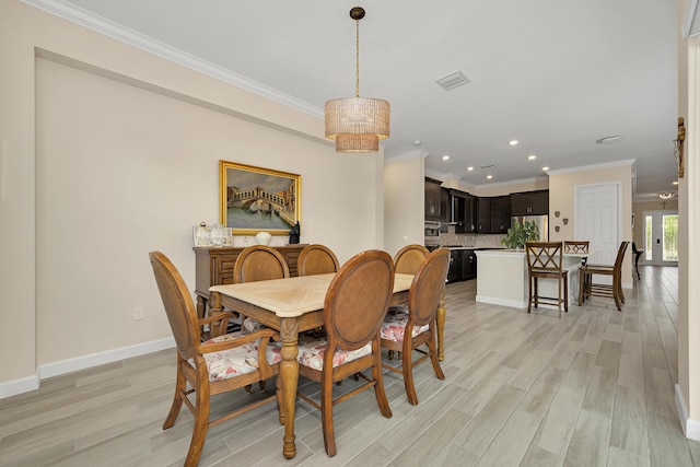 1055 Ember Ridge Run, Loxahatchee, FL 33470 - dining area with light wood-style flooring, crown molding, recessed lighting, and baseboards