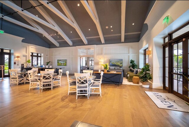 1055 Ember Ridge Run, Loxahatchee, FL 33470 - dining area with french doors, high vaulted ceiling, beam ceiling, wood finished floors, and a decorative wall