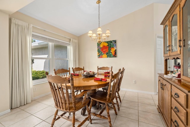 dining space featuring light tile patterned floors, vaulted ceiling, baseboards, and a notable chandelier