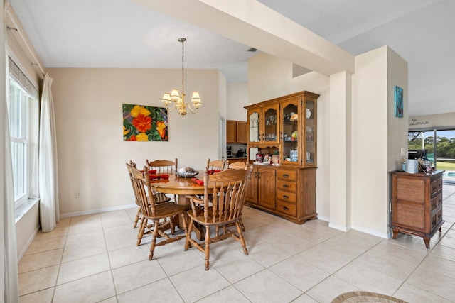 dining room with light tile patterned floors, a chandelier, baseboards, and lofted ceiling