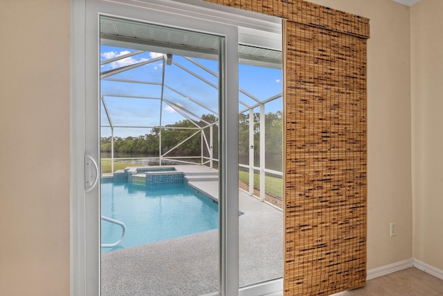view of pool featuring a lanai, a pool with connected hot tub, and a patio area