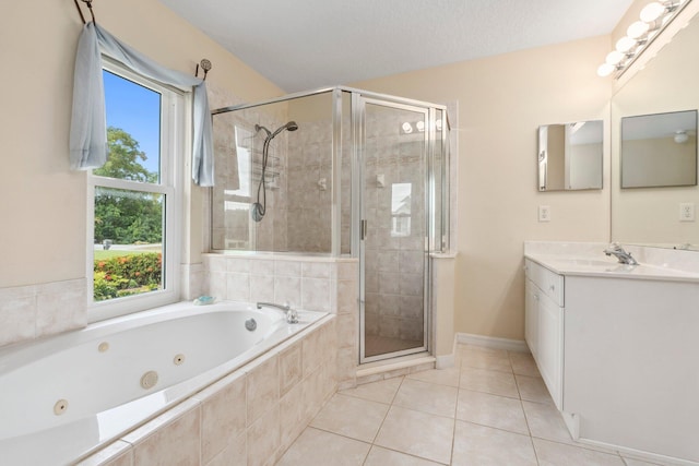 bathroom featuring a jetted tub, tile patterned floors, baseboards, a shower stall, and vanity