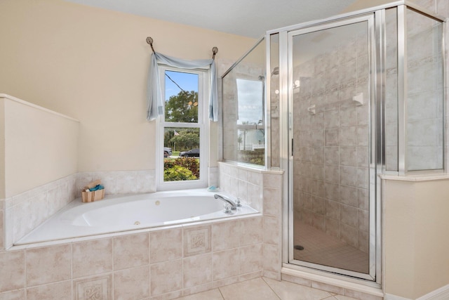 full bathroom featuring a stall shower, tile patterned flooring, a wealth of natural light, and a garden tub