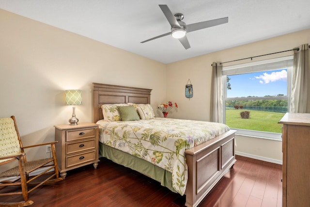 bedroom with dark wood-style flooring, baseboards, and ceiling fan